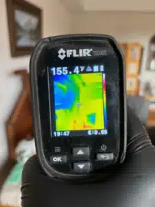 Technician monitoring room temperature during a bed bug heat treatment